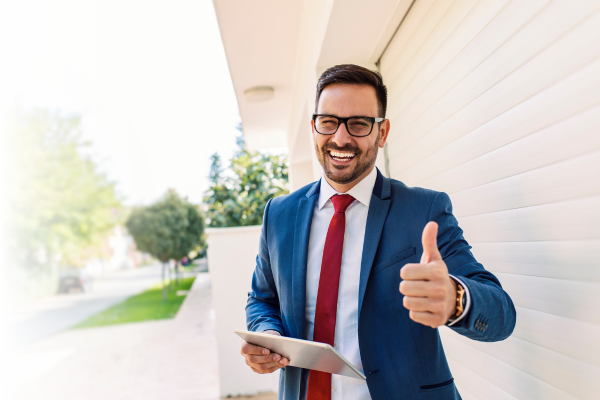 Man smiling and giving a thumbs up