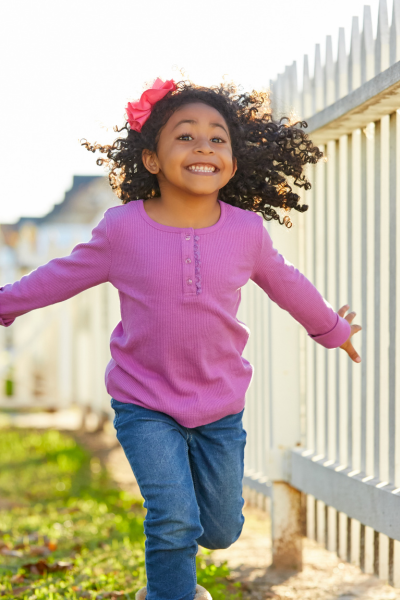 Young girl running and smiling