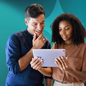 Two people reviewing content on a tablet
