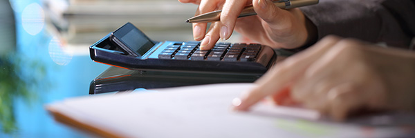 A person focused on using a calculator