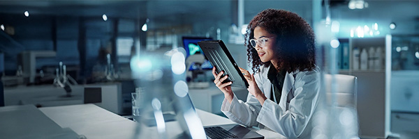 A scientist working on a tablet at a lab.