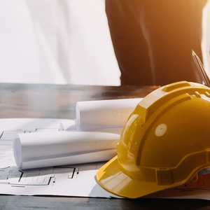 A yellow construction hard hat sitting on a table.
