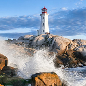lighthouse on a cliff with waves splashing