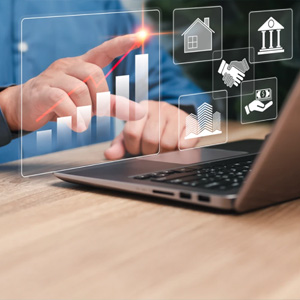 Hands using a laptop with financial growth and business icons.