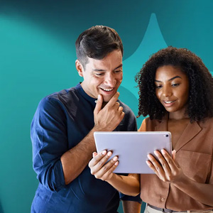 Two people reviewing content on a tablet