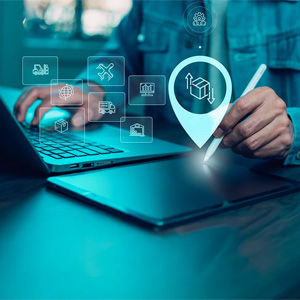 Digital logistics icons displayed over a laptop and tablet.