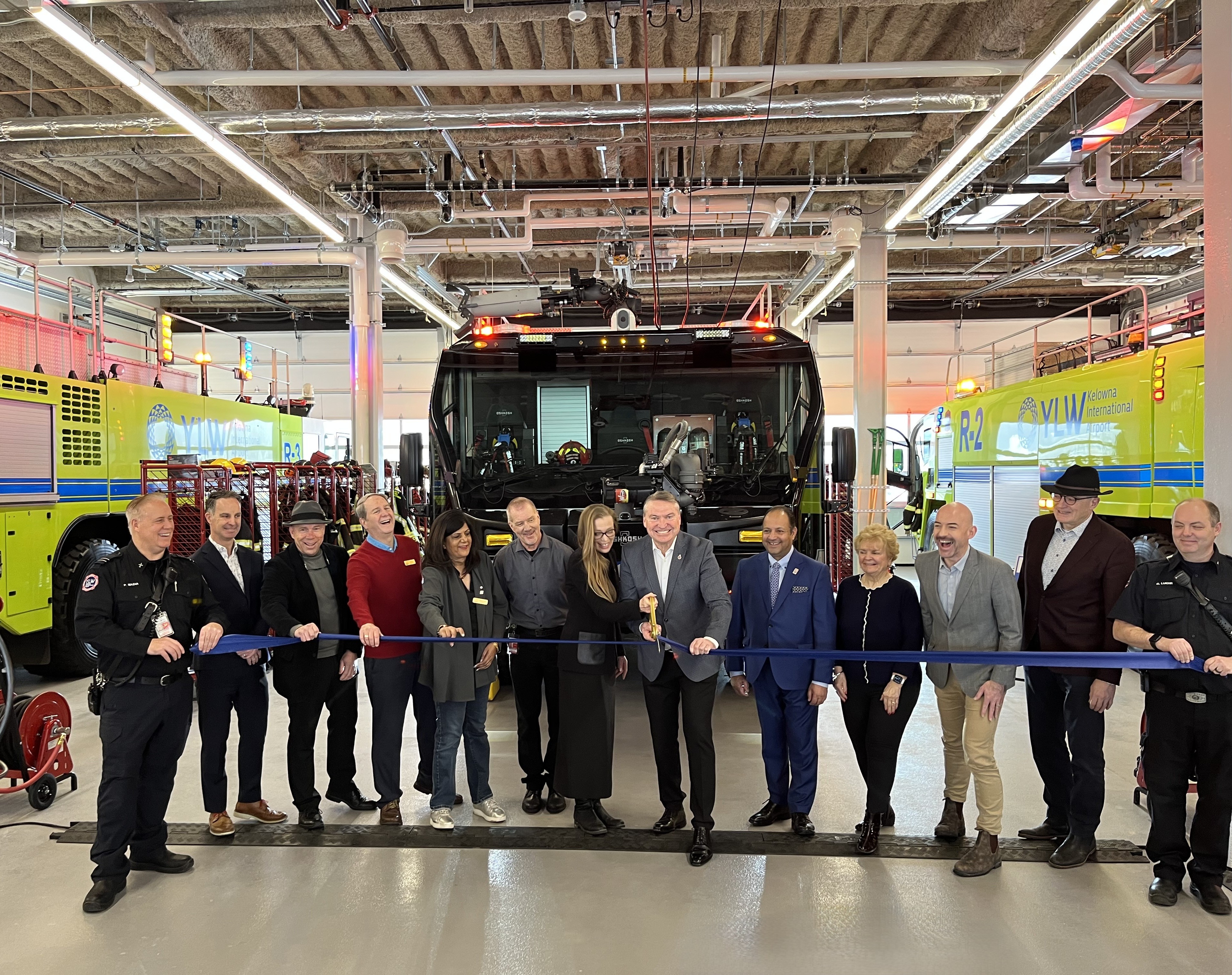 Mayor Dyas and members of Kelowna City Council join YLW CEO, Sam Samaddar, Nicole Rustad, Chief of Staff for the Office of Stephen Fuhr, and staff for the OESB official ribbon cutting.