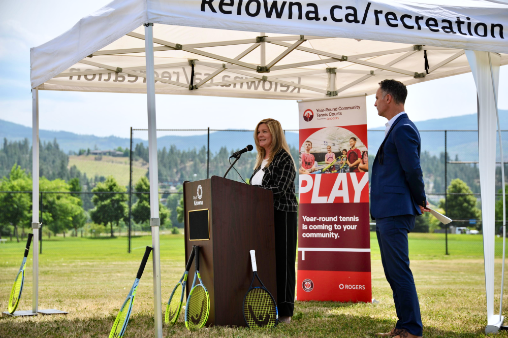 Anita Comella, Senior Director of Facilities Development, Tennis Canada speaking at a podium.