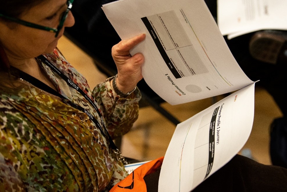 A workshop attendee reviews a handout.