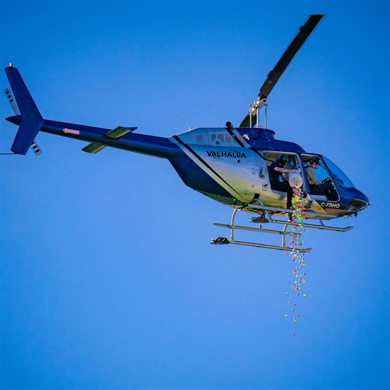 Golf balls are dropped from a helicopter to raise money in support of the YLW Scholarship Fund